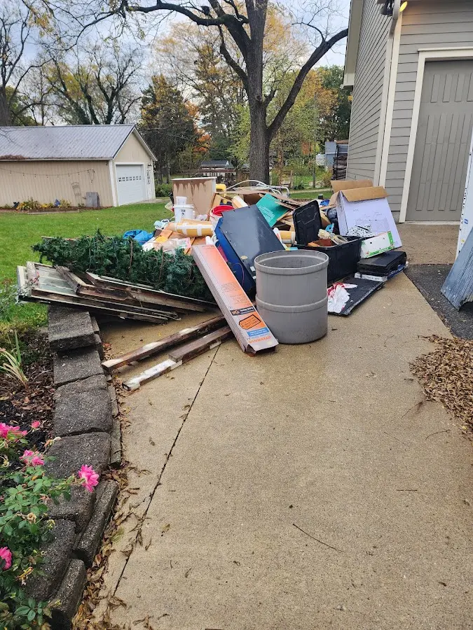 Dumpster being loaded with debris for Estate Cleanout Dumpster Rental in Fanwood